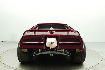 1976 Chevrolet Corvette - This custom car features a unique rear end with a prominent spoiler and exposed suspension components.
