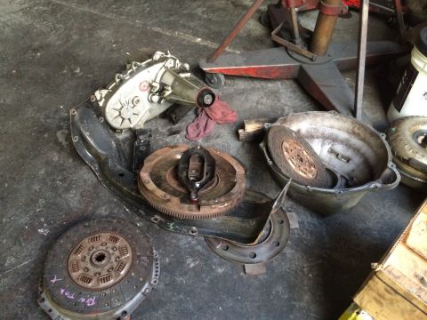 1997 Dodge 3500 - Disassembled transmission components are laid out on a workshop floor, suggesting a repair or rebuild process.
