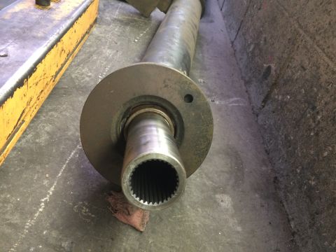 1997 Dodge 3500 - A driveshaft flange with a splined end is shown resting on the ground.