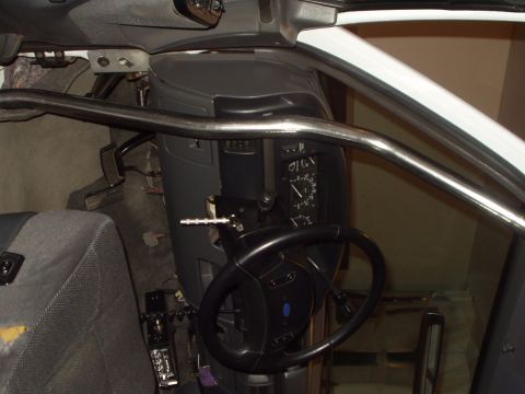 1993 Ford Bronco - The interior of a 1993 Ford Bronco shows a roll cage installed around the dashboard and driver's seat.