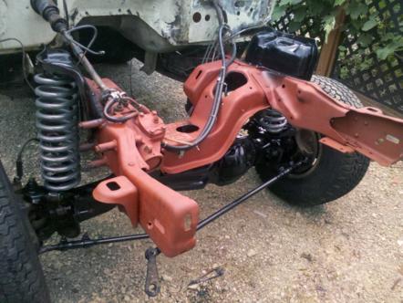 1982 Ford Bronco - The engine bay of a vehicle is shown with the frame and suspension components exposed, suggesting it is undergoing repairs or restoration.