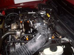 2004 Ford Crown Victoria - Close-up view of a vehicle's engine bay, showing various components and wiring.