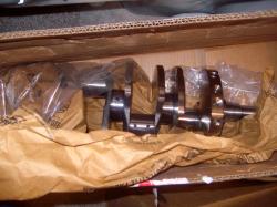 2004 Ford Crown Victoria - A new crankshaft is packaged for shipping inside a cardboard box.