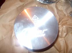 2004 Ford Crown Victoria - Close-up of a metal engine component with an engraved symbol.