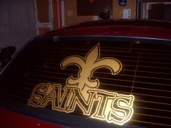 2004 Ford Crown Victoria - Rear window decal of the New Orleans Saints logo and team name.
