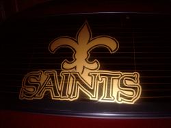 2004 Ford Crown Victoria - A gold Saints logo is affixed to the rear window of a vehicle.