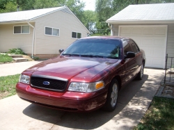 2004 Ford Crown Victoria - This 2004 Ford Crown Victoria is shown in a three-quarter front view, parked in a residential driveway.