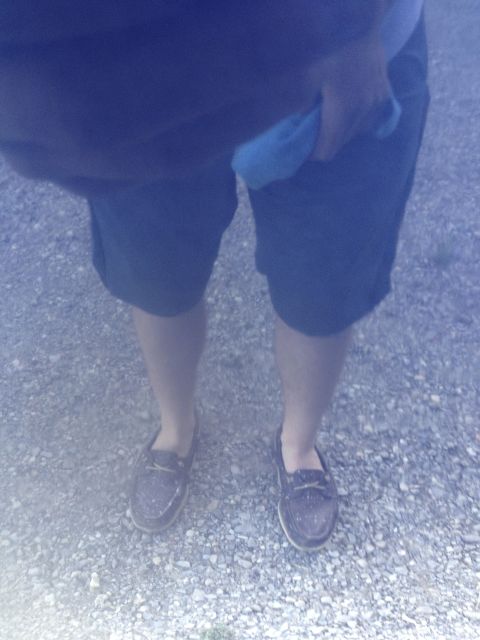 1996 Ford Bronco - A person stands on a gravel surface wearing shorts and boat shoes.