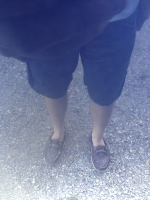 1996 Ford Bronco - A person stands on a gravel surface, wearing shorts and loafers. The Supermotors.net logo is visible at the bottom right.