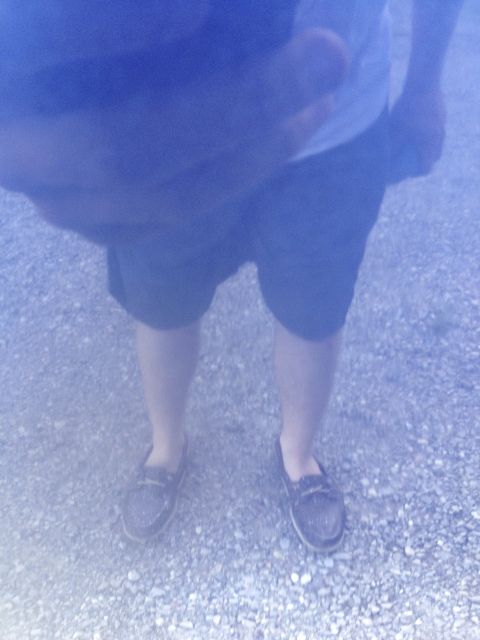 1996 Ford Bronco - A person stands on a gravel surface, viewed from the waist down.