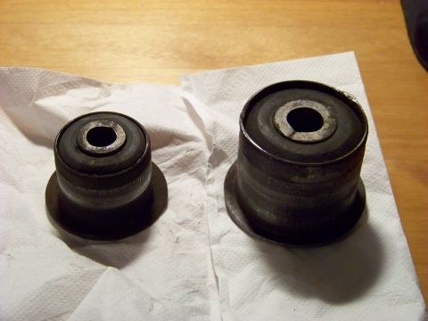 1999 Mercury Grand Marquis - Two suspension bushings are shown on a paper towel. The page claims they are for a 1999 Mercury Grand Marquis.