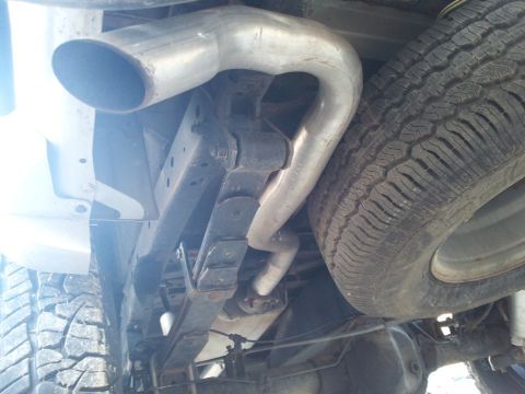 2003 Nissan Frontier - Underside view of a 2003 Nissan Frontier, showing the rear suspension components and exhaust system.