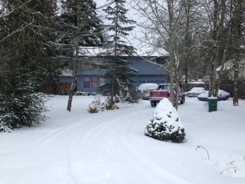 1992 Ford F-150 - A red 1992 Ford F-150 is parked in a snow-covered driveway next to other vehicles.