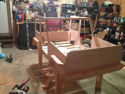 2005 Jeep Wrangler - A wooden replica of a Jeep body is being built in a garage, showing the frame and unfinished panels.