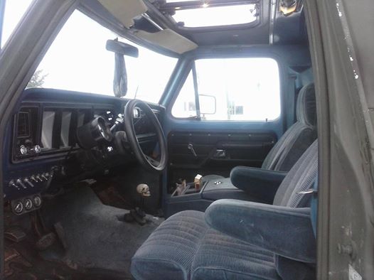 1979 Ford Bronco interior showing blue seats, dashboard, and steering wheel