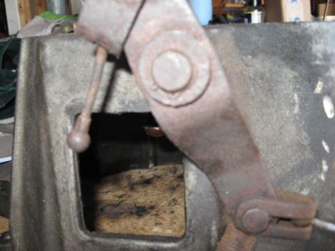 1966 Ford Falcon - A close-up view shows a rusty linkage mechanism with a rectangular opening, revealing internal components.