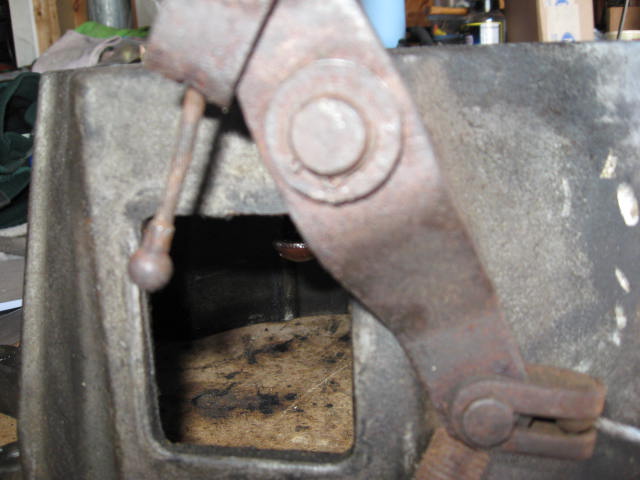 Close-up of rusty linkage mechanism with a rectangular opening