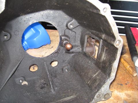 1966 Ford Falcon - Close-up of a transmission bell housing, showing internal components and a blue funnel.