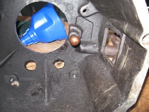 1966 Ford Falcon - Close-up view of a vehicle's bell housing interior, a blue funnel and a copper-colored pin. The registry claims this is a 1966 Ford Falcon,…