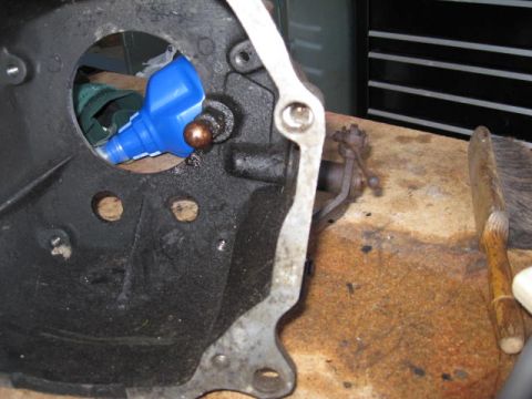 1966 Ford Falcon - Clutch fork and bell housing assembly with a blue bottle visible inside.