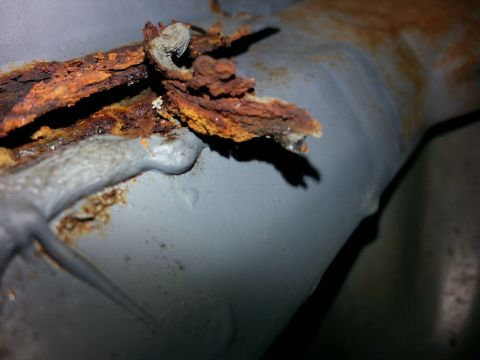 1992 Ford Bronco - Severe rust and corrosion are evident on this metal seam, indicating significant body work is needed.