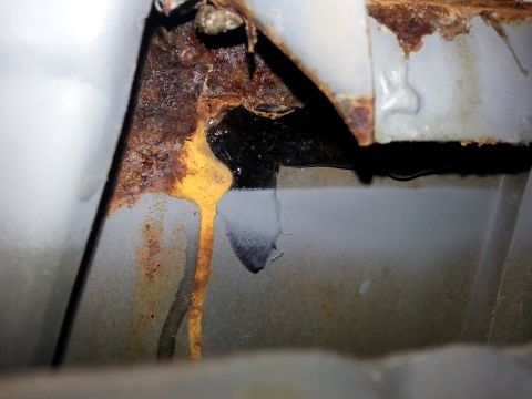 1992 Ford Bronco - Extensive rust damage is visible on this vehicle's body, indicating significant deterioration.