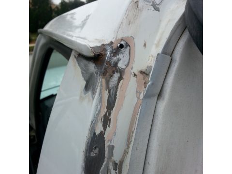 1992 Ford Bronco - This photo shows extensive body work and rust repair on the upper corner of a vehicle's body.