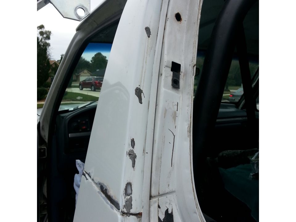 these gray blobs are the remnants of the holes from my old soft top bracket. will smooth them down then cover over with filler and seam sealer from the inside.