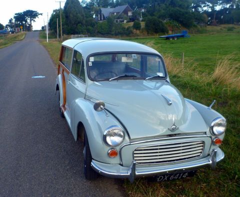 1969 MINI Cooper - Morris Minor Traveller, a classic British car, parked beside a rural road.