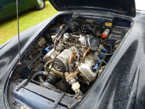 1969 MINI Cooper - Close-up view of a car's engine bay with the hood open.