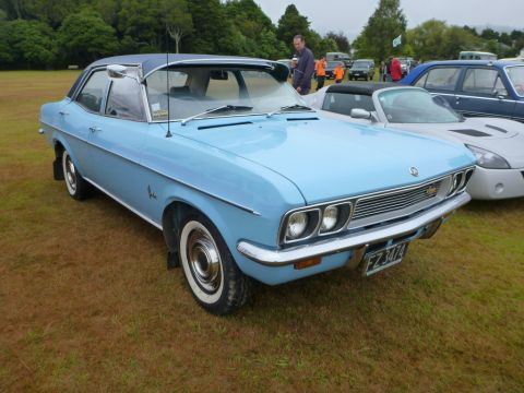 1969 MINI Cooper - This light blue sedan with a dark blue roof is parked on grass at an outdoor event.