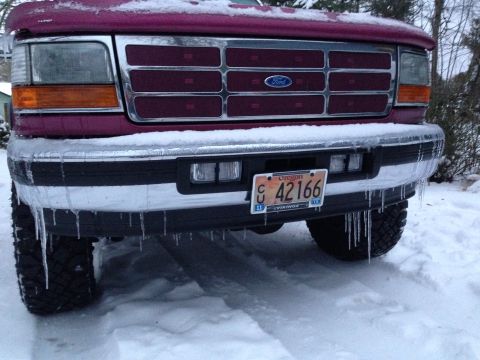 1992 Ford F-150 - Icicles hang from the bumper of a maroon Ford truck covered in snow.