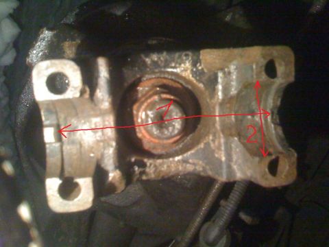 1987 Ford Bronco - This image shows a close-up of a driveshaft U-joint bearing cap, likely for measurement or inspection purposes.