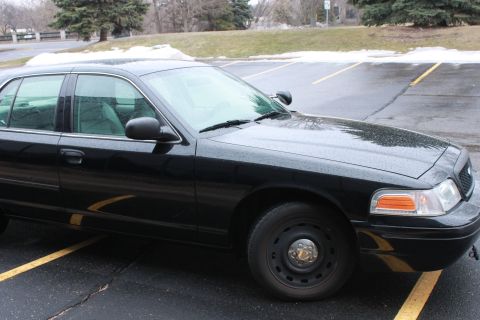 2005 Ford Crown Victoria - This black 2005 Ford Crown Victoria is shown from a 3/4 front angle in a parking lot.