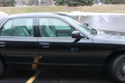 2005 Ford Crown Victoria - 2005 Ford Crown Victoria side profile, showing the doors, windows, and a spotlight.