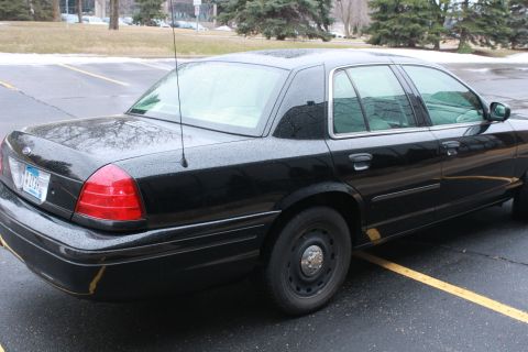 2005 Ford Crown Victoria - This black sedan's body style suggests a model year around 2003, not 2005.