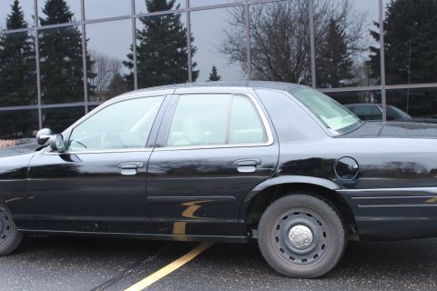 2005 Ford Crown Victoria - Side profile of a black sedan, likely a Ford Crown Victoria, parked outdoors.