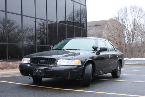 2005 Ford Crown Victoria - A black 2005 Ford Crown Victoria is shown from a three-quarter front angle in a parking lot.