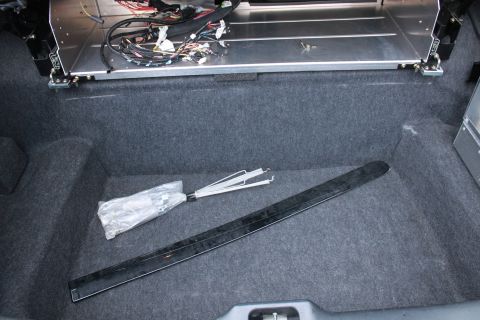 2005 Ford Crown Victoria - The trunk of a car is shown with various components and wiring exposed.