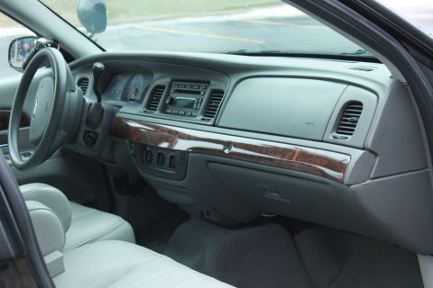 2005 Ford Crown Victoria - Interior view of a 2005 Ford Crown Victoria, highlighting the dashboard and seating.