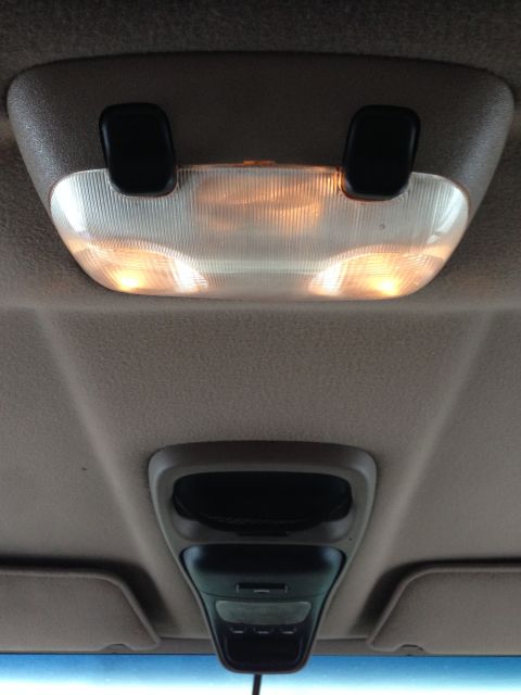 1996 Ford Bronco - Vehicle interior overhead console lights and a storage compartment.