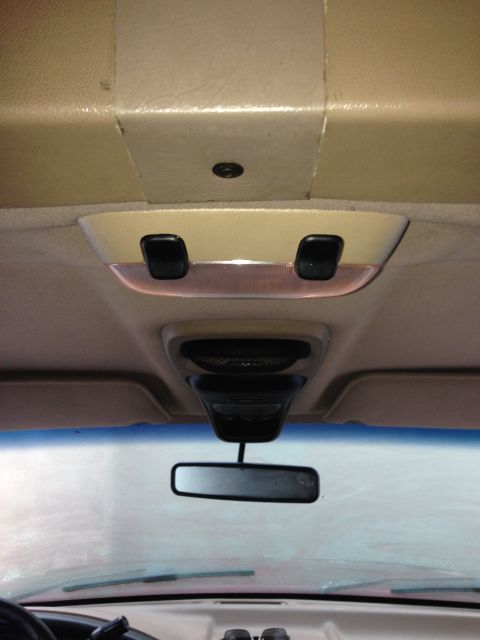 1996 Ford Bronco - Interior view of a vehicle's overhead console and rearview mirror.