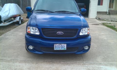 2003 Ford F-150 - Front view of a blue 2003 Ford F-150 Lightning, parked in front of a garage.
