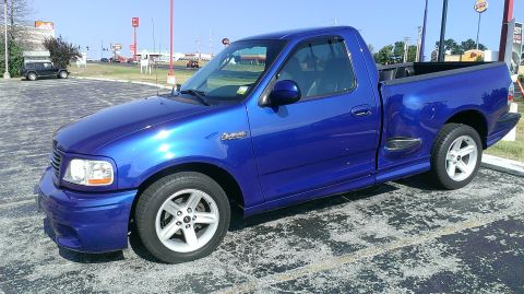 2003 Ford F-150 - This blue 2003 Ford F-150 pickup truck is shown from a 3q-front angle.