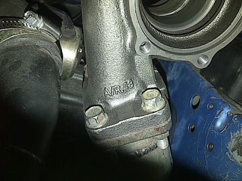 1995 Ford Probe - Close-up of a turbocharger component, showing part markings and bolted connections.