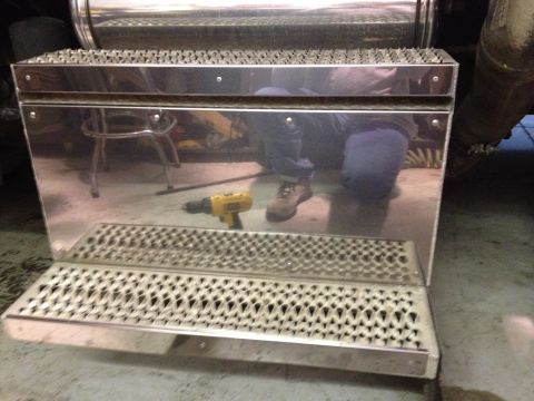 2003 Peterbilt 379 - Chrome step box with diamond plate tread and a yellow drill on the surface.