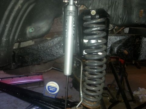 1996 Ford Bronco - Vehicle suspension components, including a FOX shock and coil spring, are visible in this close-up shot.