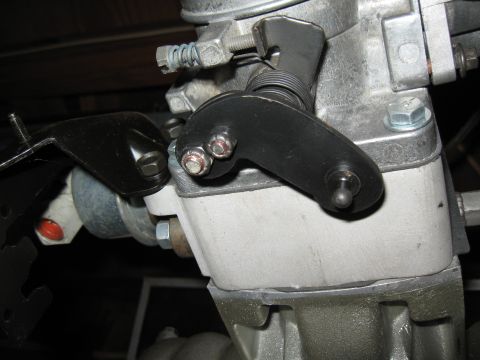 1994 Ford Bronco - Detail of a carburetor linkage mechanism, showing mechanical components and fasteners.