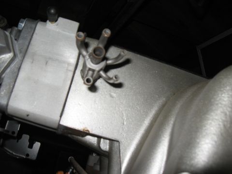 1994 Ford Bronco - Close-up of an engine component with several small tubes.