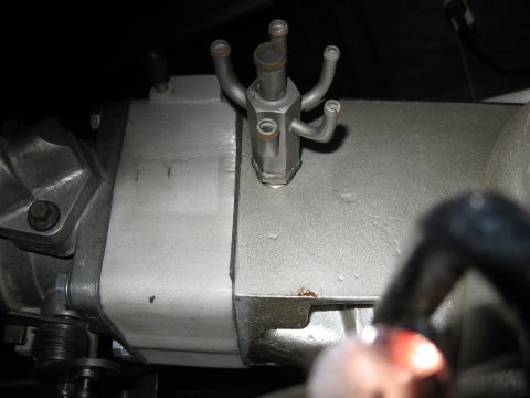 1994 Ford Bronco - This is a close-up view of an engine part with several small hoses connected to it.